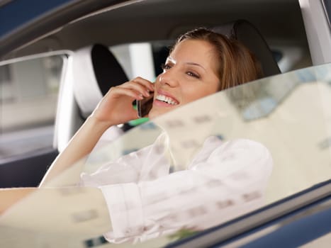 woman driving car and talking on mobile phone.