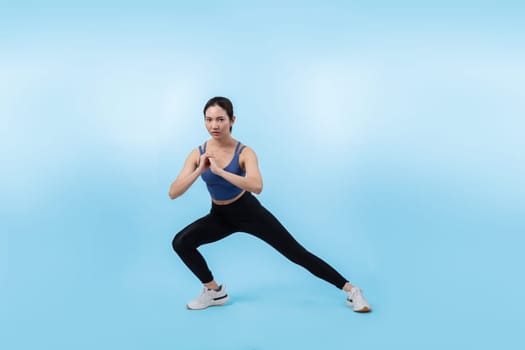 Young attractive asian woman in sportswear stretching before fitness exercise routine. Healthy body care workout with athletic woman warming up on studio shot isolated background. Vigorous