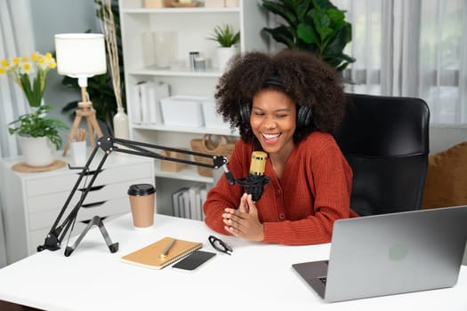 Host channel of beautiful African woman talking in online broadcast teaching marketing influencer, with listeners in broadcast or online. Concept of anywhere at work place. Tastemaker.