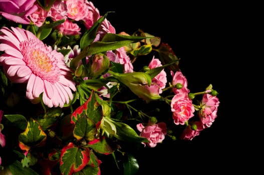 pink bouquet of flowers against black background