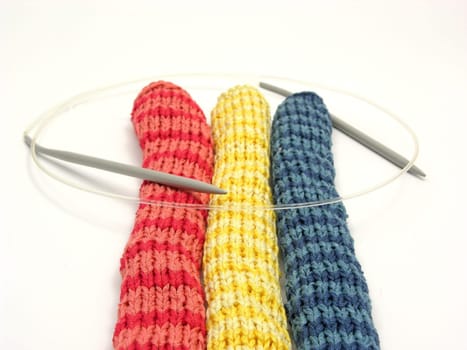 Three striped self-knitted scarves with circular needle