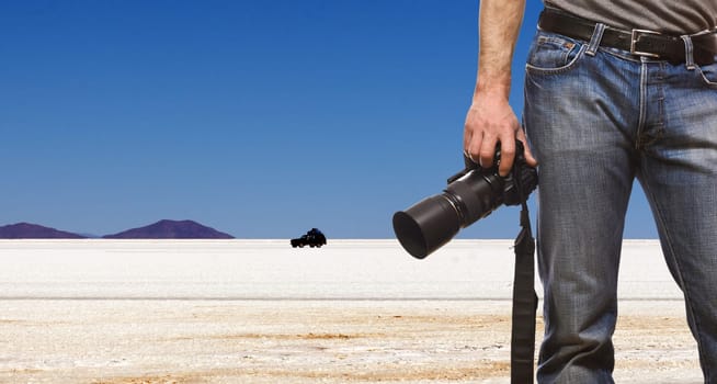 detail of photographer and desert landscape background