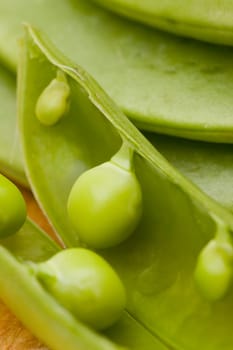 fresh peas on wooden background
