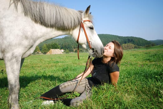 Young woman with riding pony