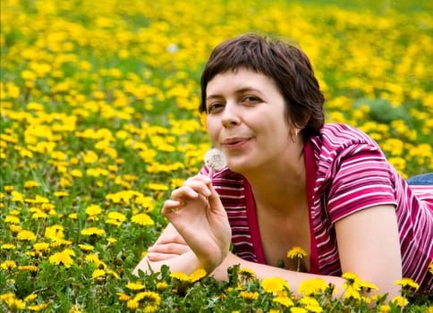 Young woman lying in a meadow