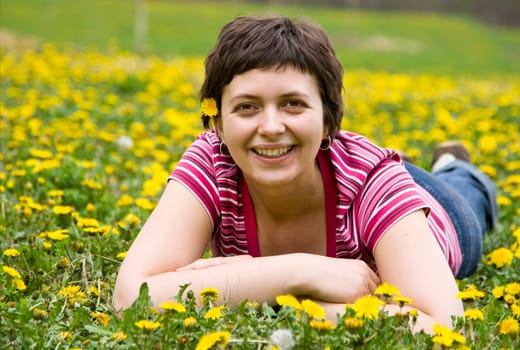 Young woman lying in a meadow