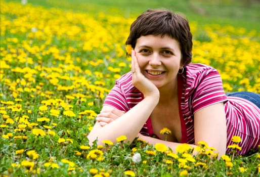 Young woman lying in a meadow