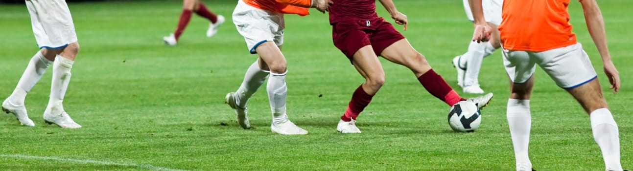 Soccer players fighting for the ball