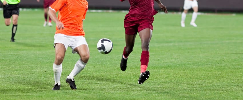Soccer players fighting for the ball
