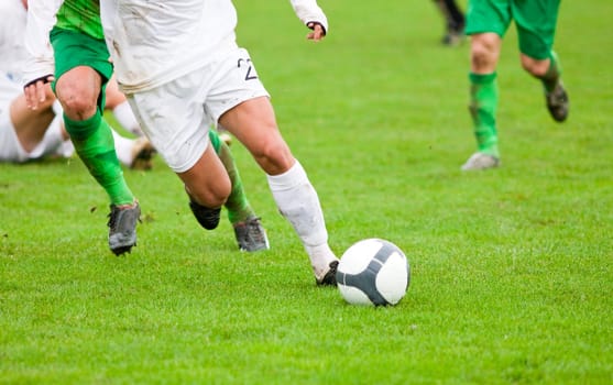 Soccer players fighting for the ball