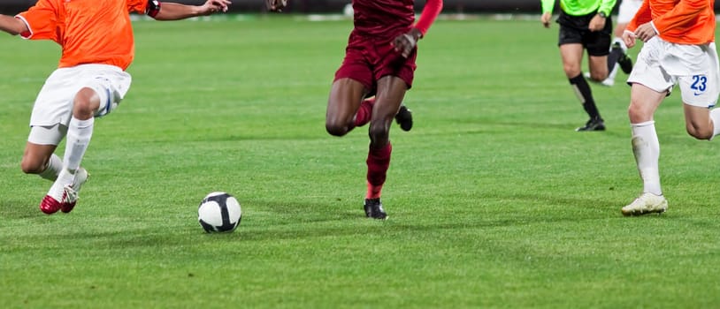 Soccer players fighting for the ball