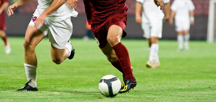 Soccer players fighting for the ball