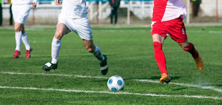 Soccer players fighting for the ball