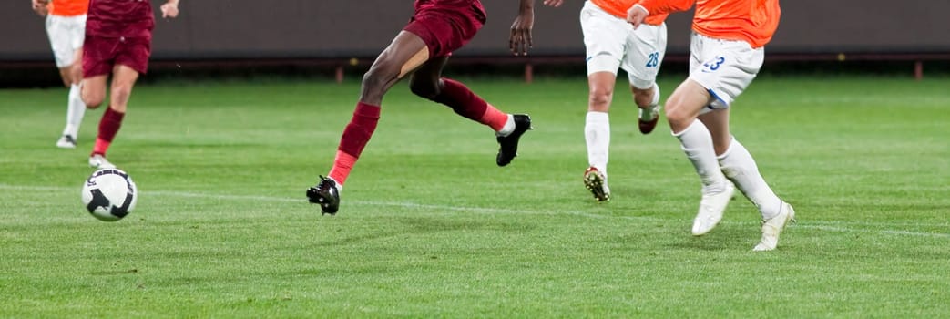 Soccer players fighting for the ball