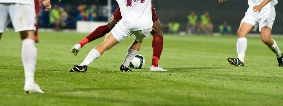 Soccer players fighting for the ball