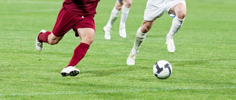 Soccer players fighting for the ball