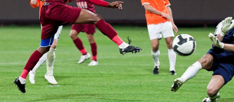 Soccer players fighting for the ball