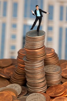 Businesswoman balancing on coins