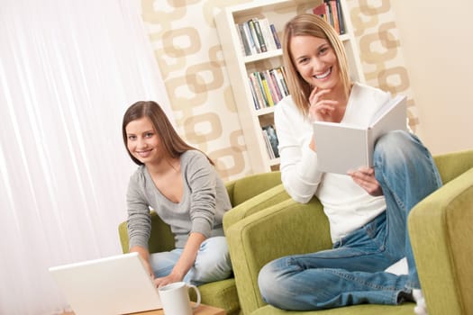 Two female students relaxing in lounge