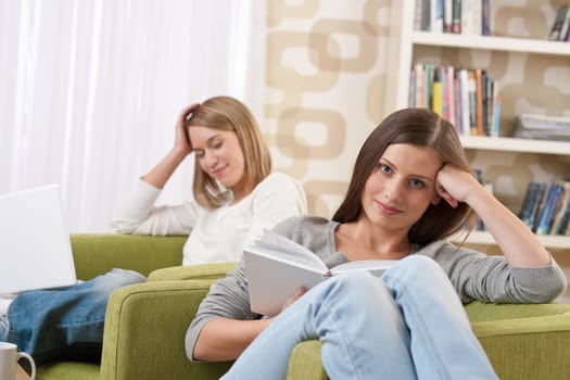Two female students relaxing in lounge