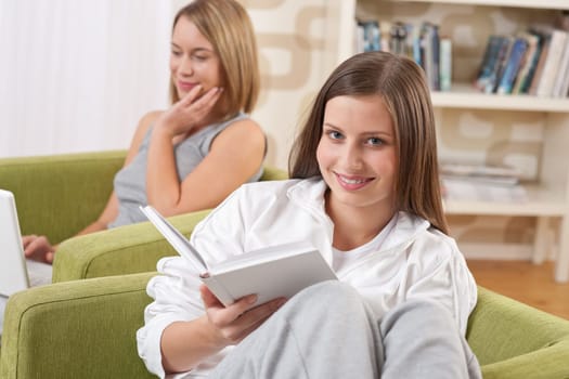 Two female students relaxing home