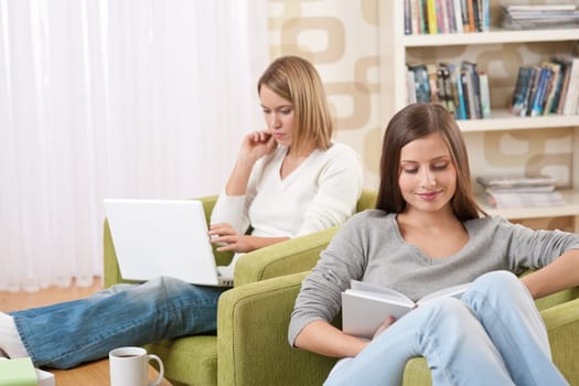 Two female students relaxing in lounge