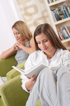 Two female students relaxing home