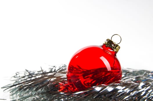 red Christmas ball on silver tinsel