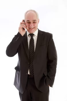 Laughing, older businessman in a suit and has telephoned
