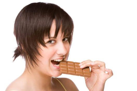 Young woman biting into a piece of chocolate