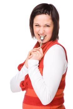 Young woman with a spoon in her mouth