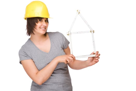 Young woman with a construction helmet and a folding rule