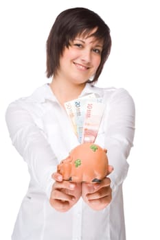 Young woman with a piggy bank