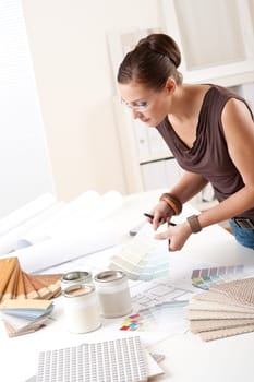 Young female interior designer at office