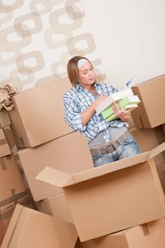 Moving house Woman unpacking box