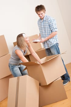 Moving house Couple unpacking box