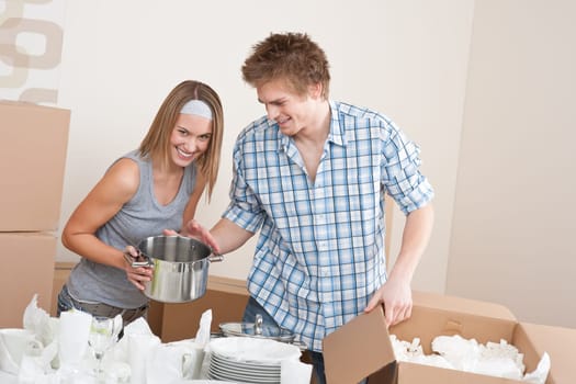 Moving house Couple unpacking box