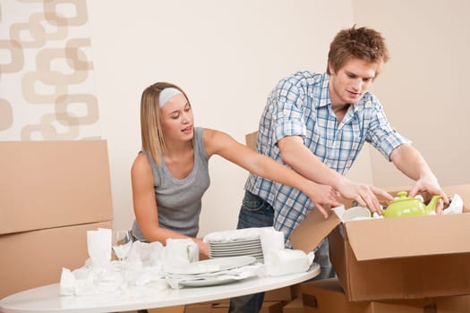 Moving house Couple unpacking box