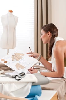Female fashion designer working at studio