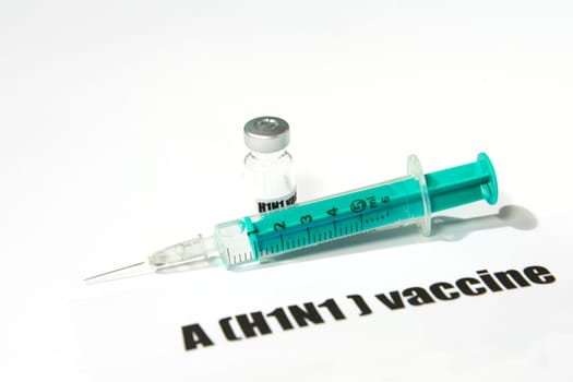 Swine FLU H1N1 disease - syringe and vaccine on white background