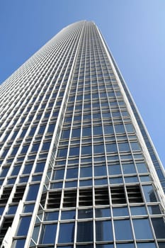 Skyscraper reaching out to blue sky