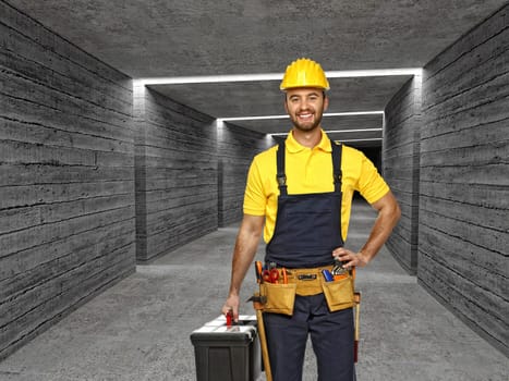 manual worker in concrete tunnel backgro