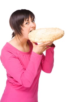 Young woman bites into a cake