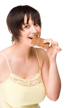 Young woman biting into a piece of chocolate