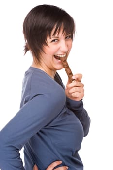 Young woman snacking on a chocolate bar.