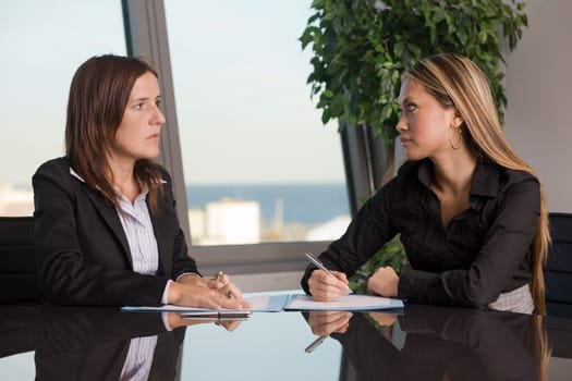 Two businesswomen looking at each other