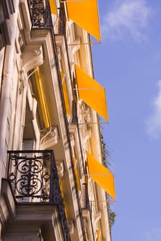 House façade with yellow awnings
