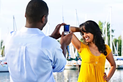 Woman posing for picture near boats