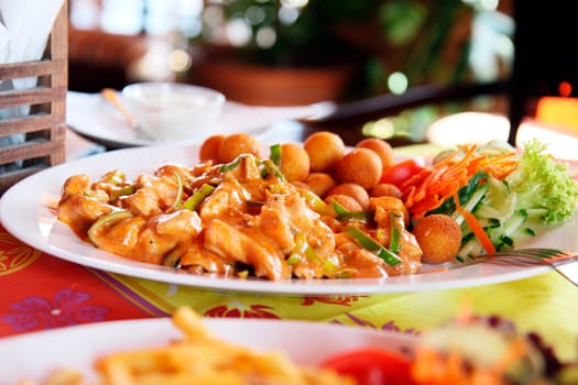 chinese food with croquettes and vegetable