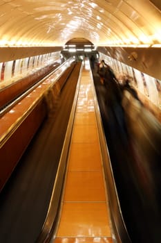 escalator with people in Prague underground - blurred foregrounding movement